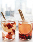 Bamboo straws placed in two jars of fruity drinks