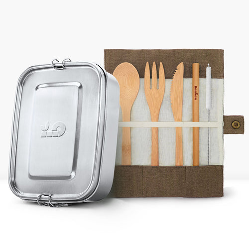Silver lunch tin beside a roll up fabric pouch containing wooden cutlery.